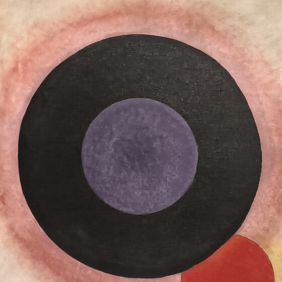 The large black circle with a purple centre and a pink halo in the top left corner of the painting