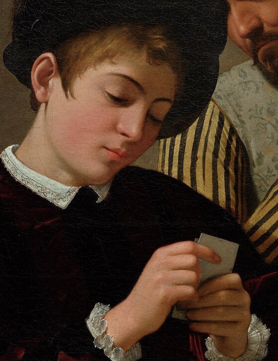 The young man in black velvet and a lace collar looking down at the cards in his hand