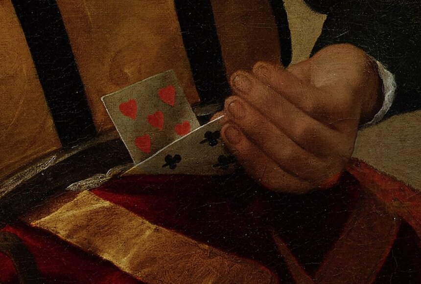 The cheat's hand behind his back pulling a five of hearts from his belt, a dagger beside it
