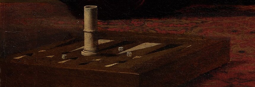 The backgammon board, dice cup and scattered cards on the carpet-covered table