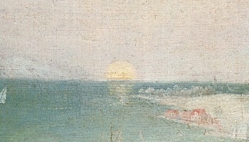 The sun low on the horizon over a pale sea and distant coast