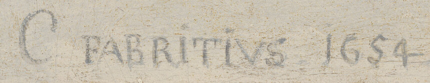 The signature C FABRITIVS 1654 painted on the wall beneath the feeding box