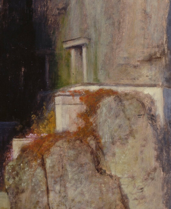Doorways and windows cut into the rock face on the right of the island, with the initials A B carved above one