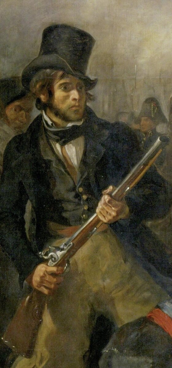 A man in a black top hat and coat holding a hunting gun at the barricade