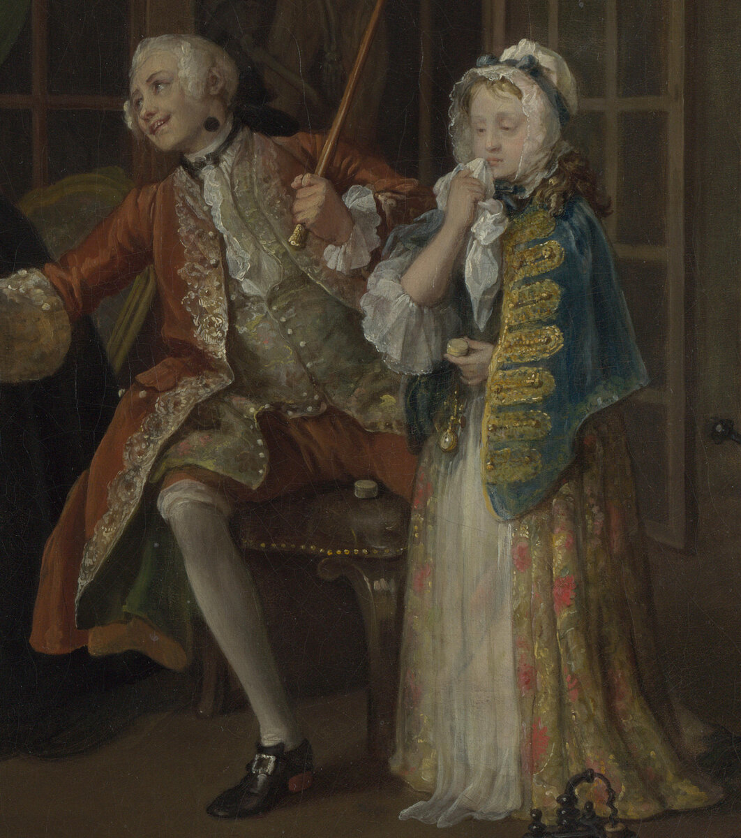 The Viscount seated in a red coat holding up a pillbox on the end of his cane, smiling, with a very young girl beside him dabbing a sore on her mouth