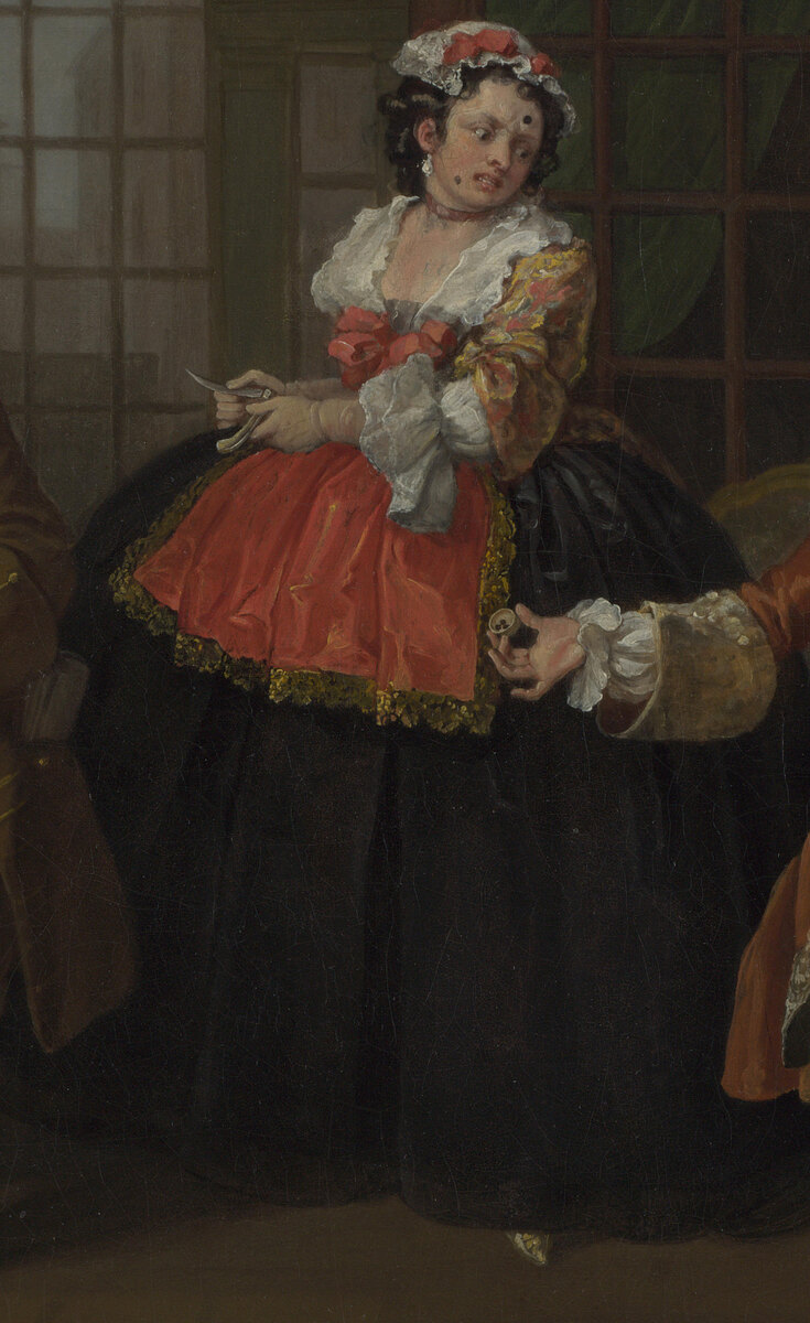 A tall woman in a black gown and red apron standing over the group opening a clasp knife, her face marked with black patches