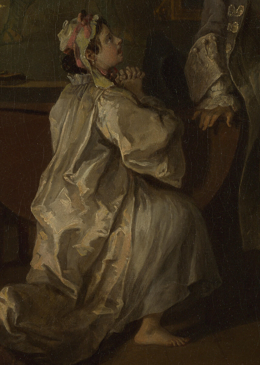 The Countess kneeling on the floor in her white shift with her hands clasped, looking up at her dying husband
