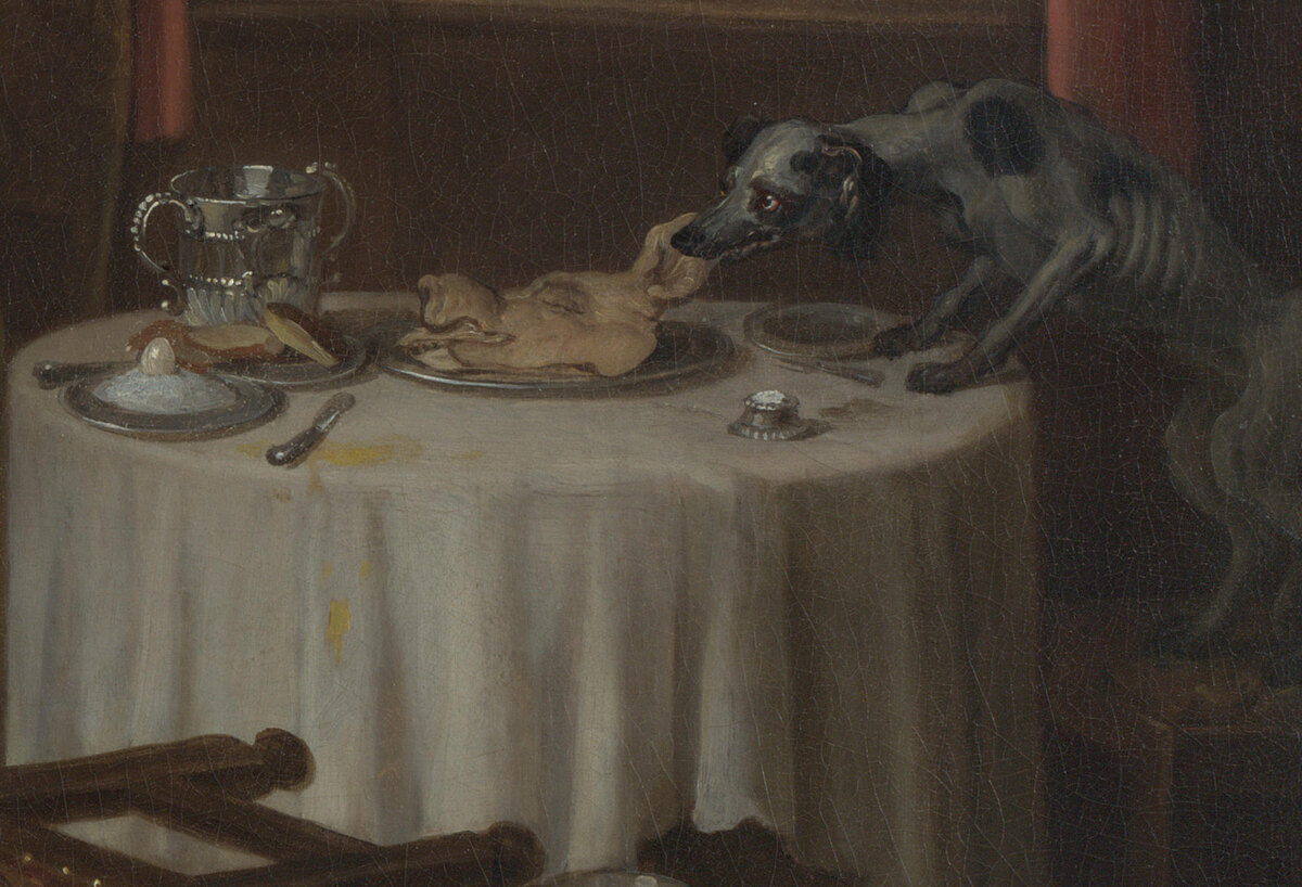 A starving dog with its ribs showing pulling a pig's head off a plate on the dinner table