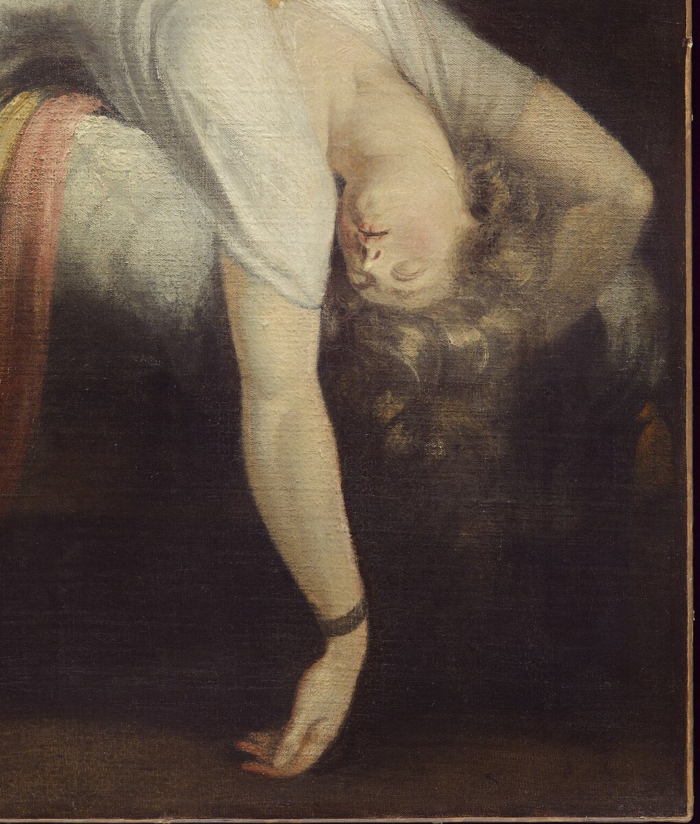 Close view of the sleeper's face upside down, eyes closed, hair falling, and her hand hanging to the floor