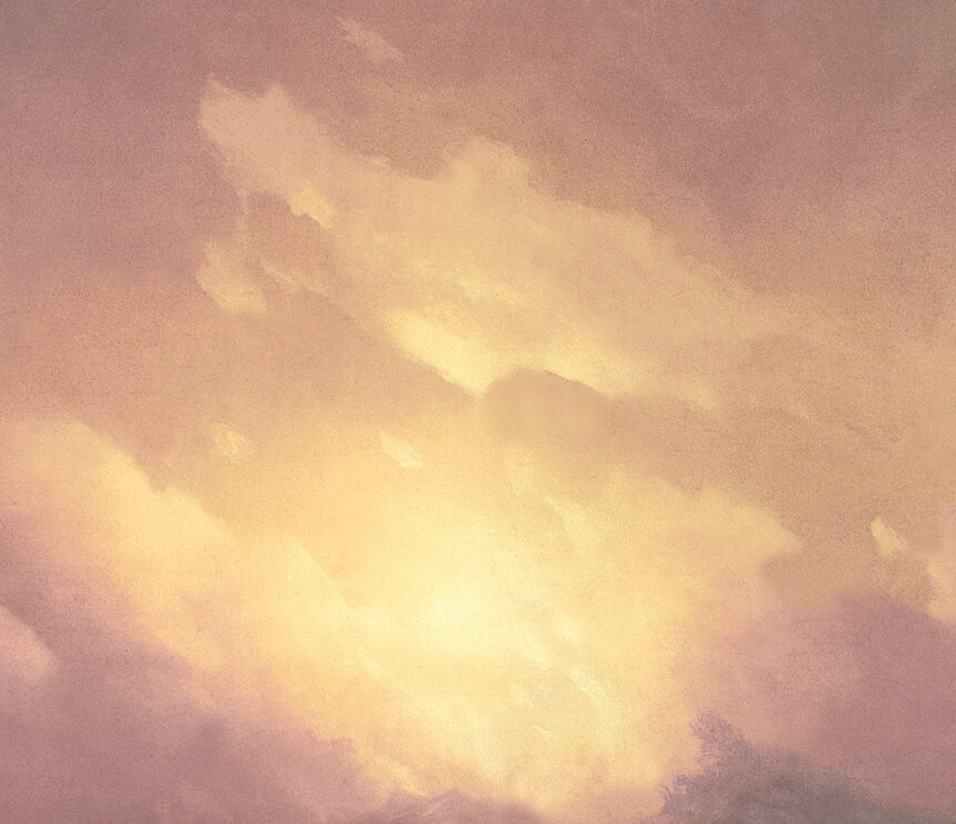 The rising sun breaking through storm clouds in gold and pink above the sea