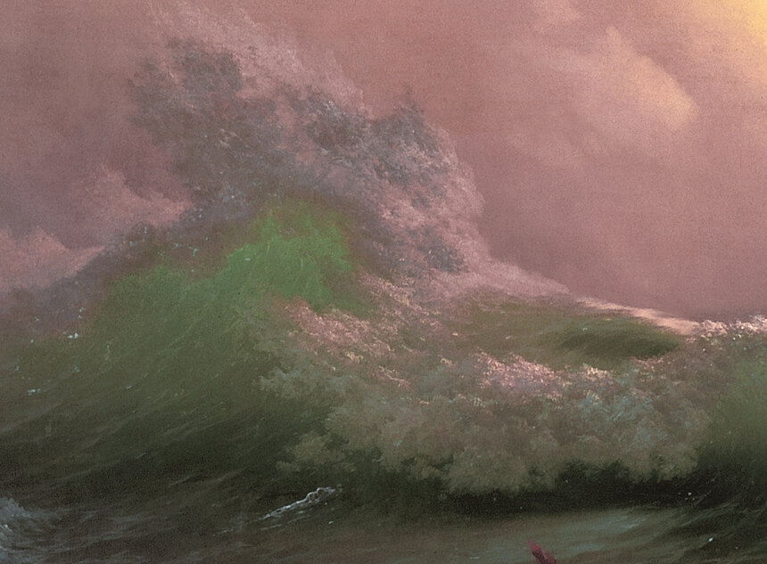 The crest of a huge green wave, translucent where the light comes through it, foam blowing off the top