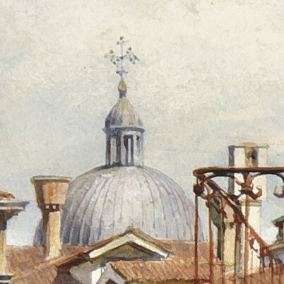 A grey dome with a lantern and cross rising over the tiled roofs