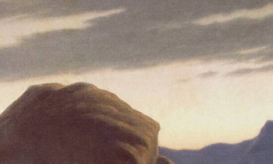 Dawn breaking in a pale band over the blue mountains of the wilderness