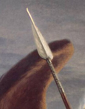 The iron point of Satan's spear against the grey sky beside his wing