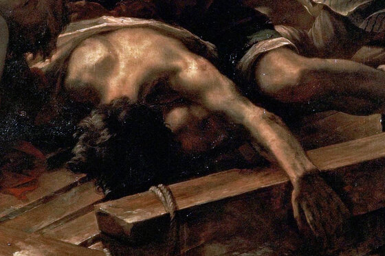 A man lying face down on the raft with his arm outstretched