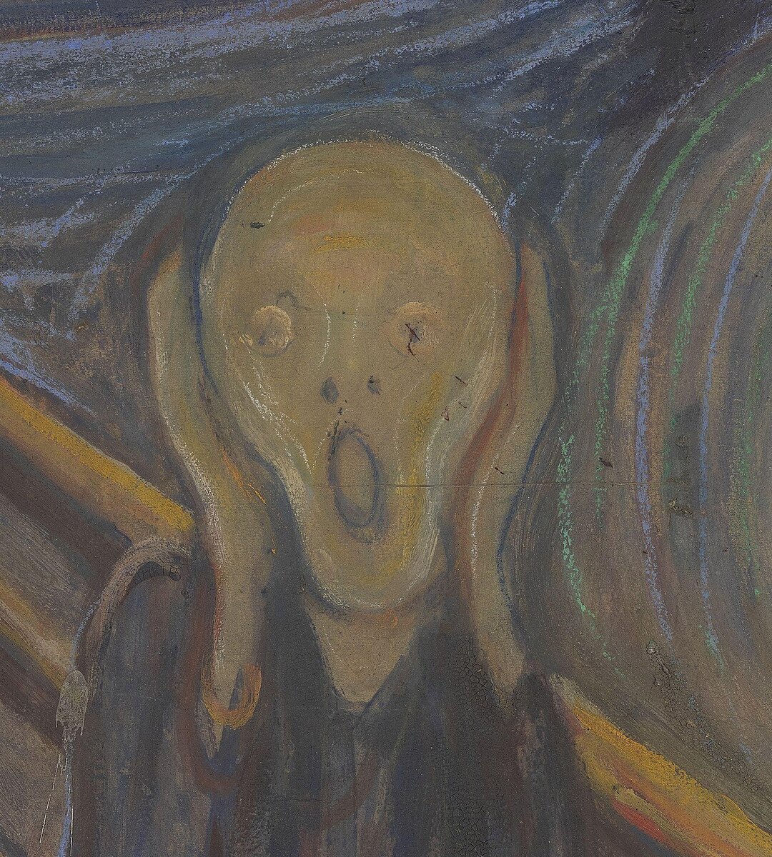 The pale bald face with wide eyes and open mouth, both hands pressed to the sides of the head