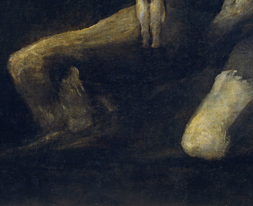 Saturn's bent knees and lower body crouched in the darkness