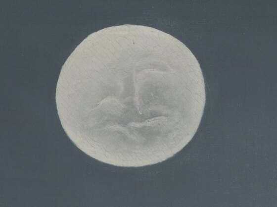 The full moon with a face and a few stars in the deep blue night sky