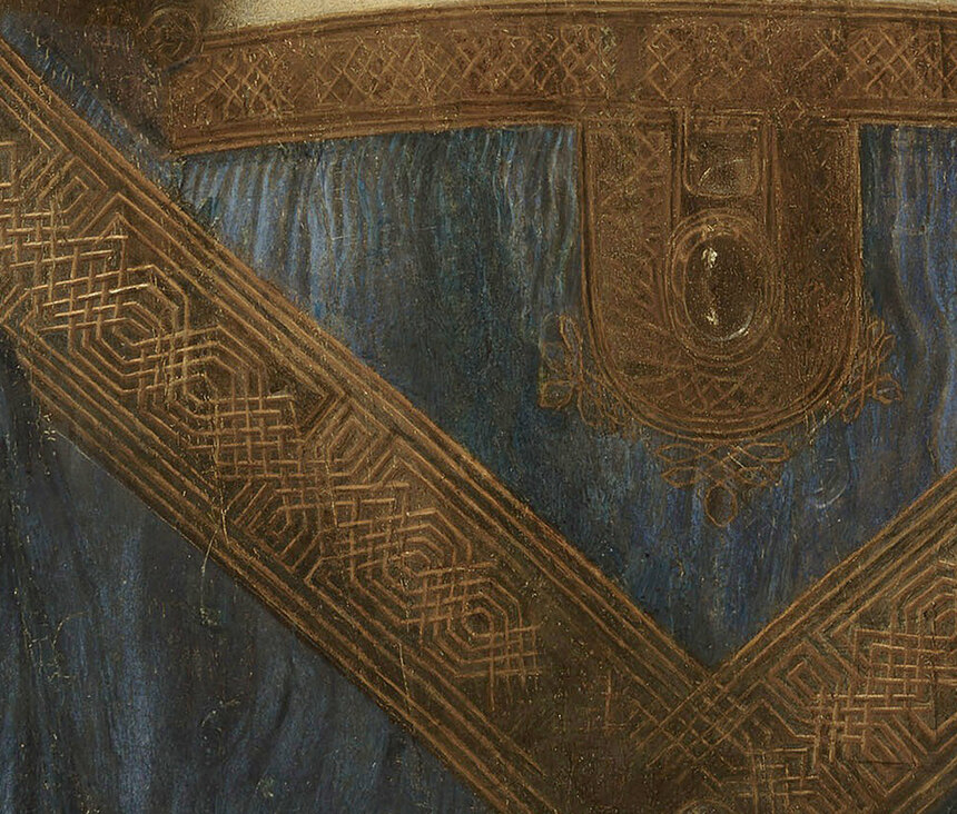 The crossed embroidered bands on Christ's robe, with a jewelled clasp at the centre