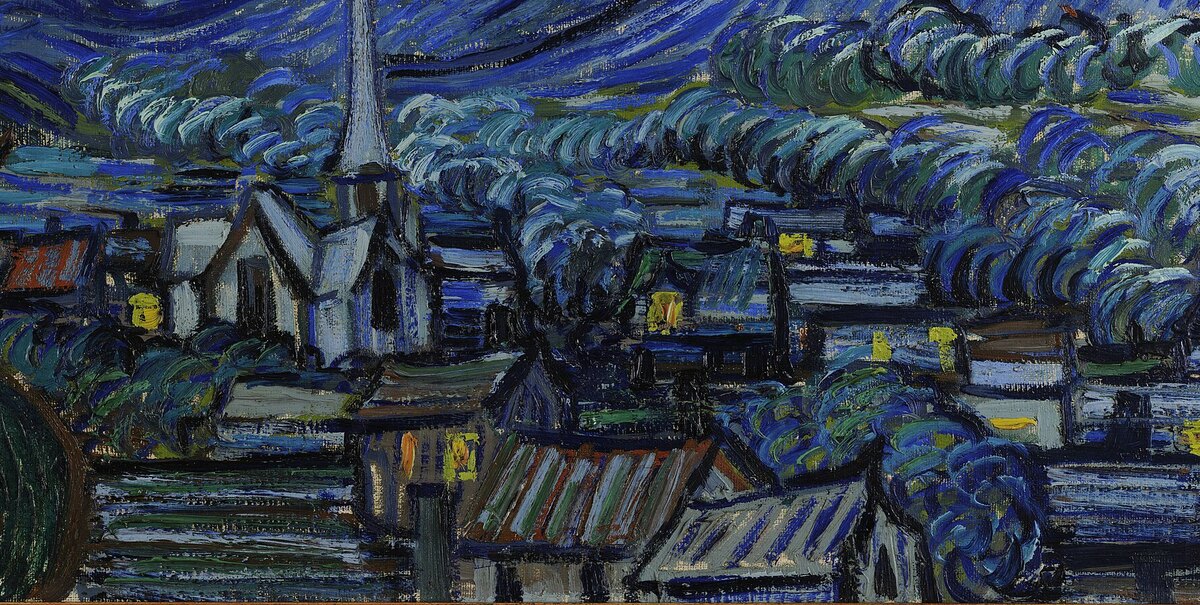 The village at the foot of the hills with a tall thin church steeple and lit windows