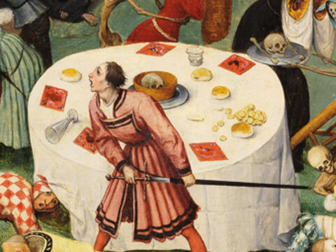 An overturned dinner table with cards and dice, a jester escaping under it, skeletons in masks