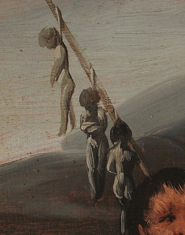 A stick planted in the ground with three small dead babies hanging from it