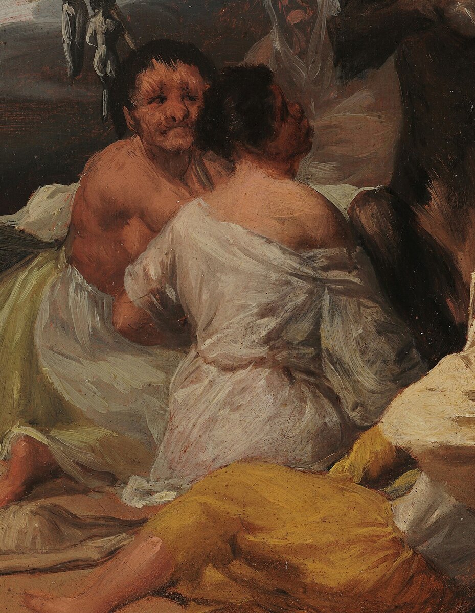 Two witches seated on the left, one with her back to us, looking at the goat