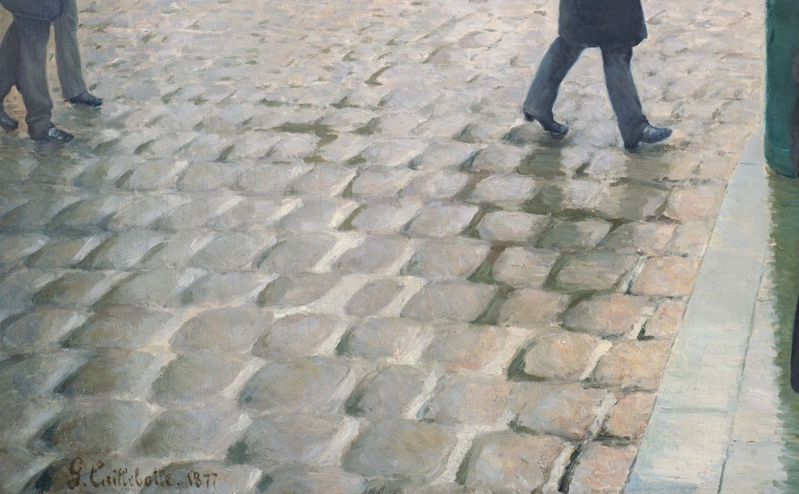 Wet cobblestones and pale reflections in Caillebotte’s rainy Paris street