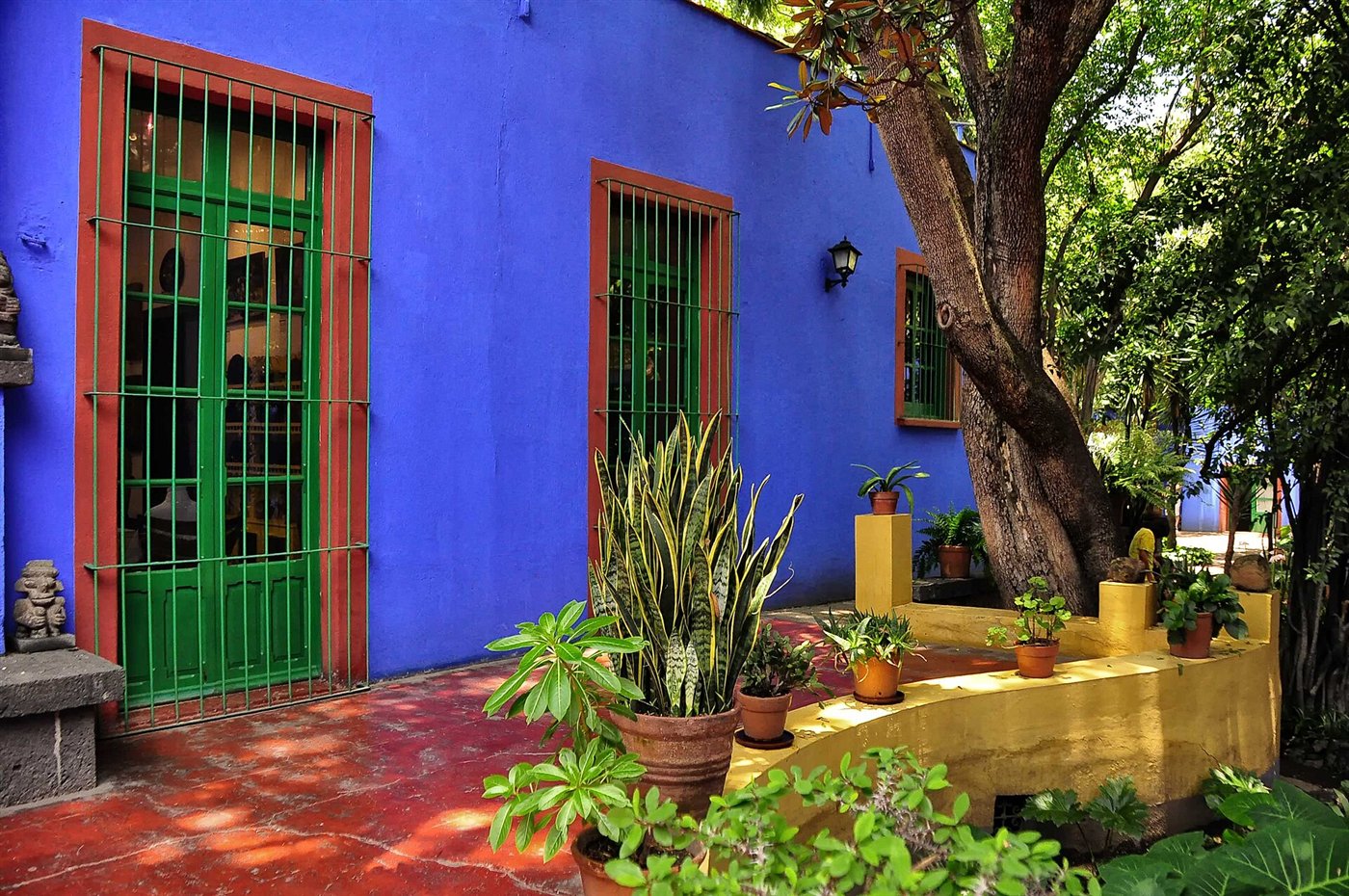 The cobalt blue walls and green window frames of the Casa Azul, Frida Kahlo's house in Coyoacán, now the Museo Frida Kahlo