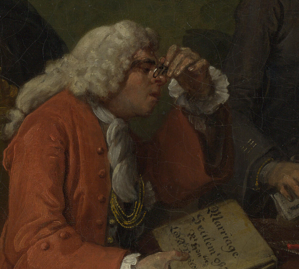 The Alderman in a red coat peering through spectacles at the marriage settlement