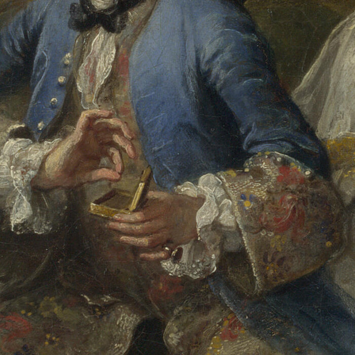 The groom's hands taking a pinch of snuff from a small gold box