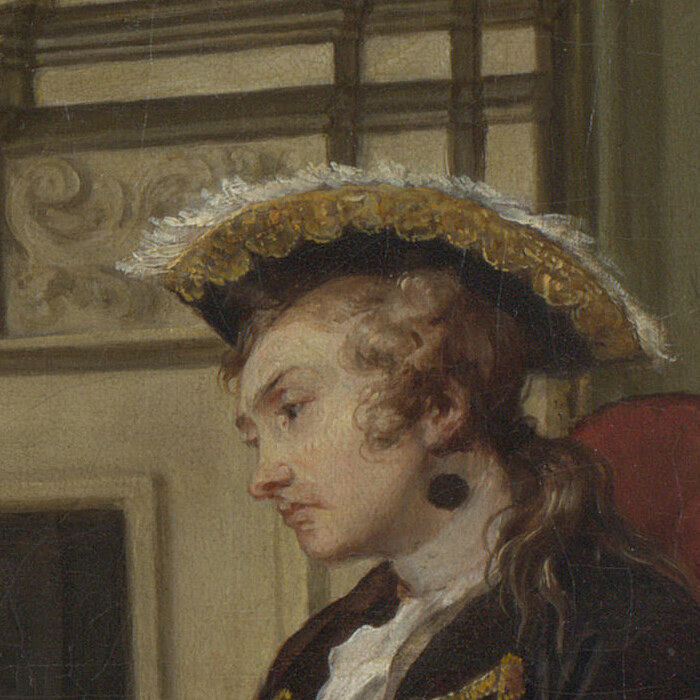 The husband's profile under his hat with a black spot on his neck