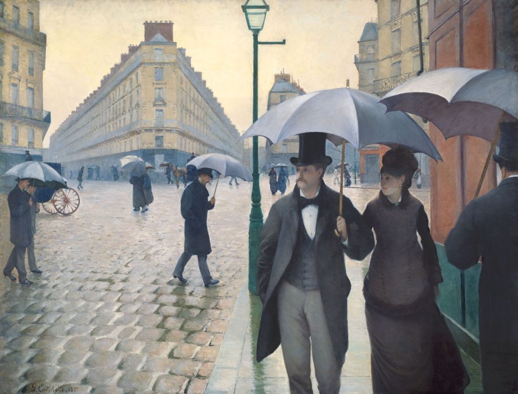 Paris Street Rainy Day by Gustave Caillebotte, a couple under an umbrella walking on wet cobblestones at a wide Paris crossroads with a lamppost in the centre